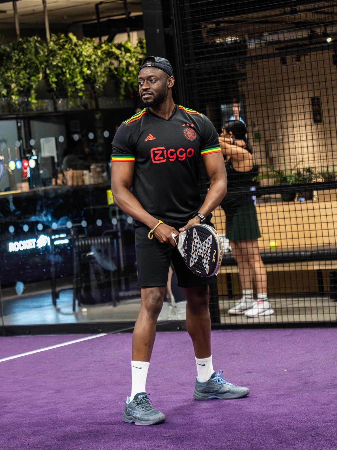Guest holding a padel racket ready to start a match