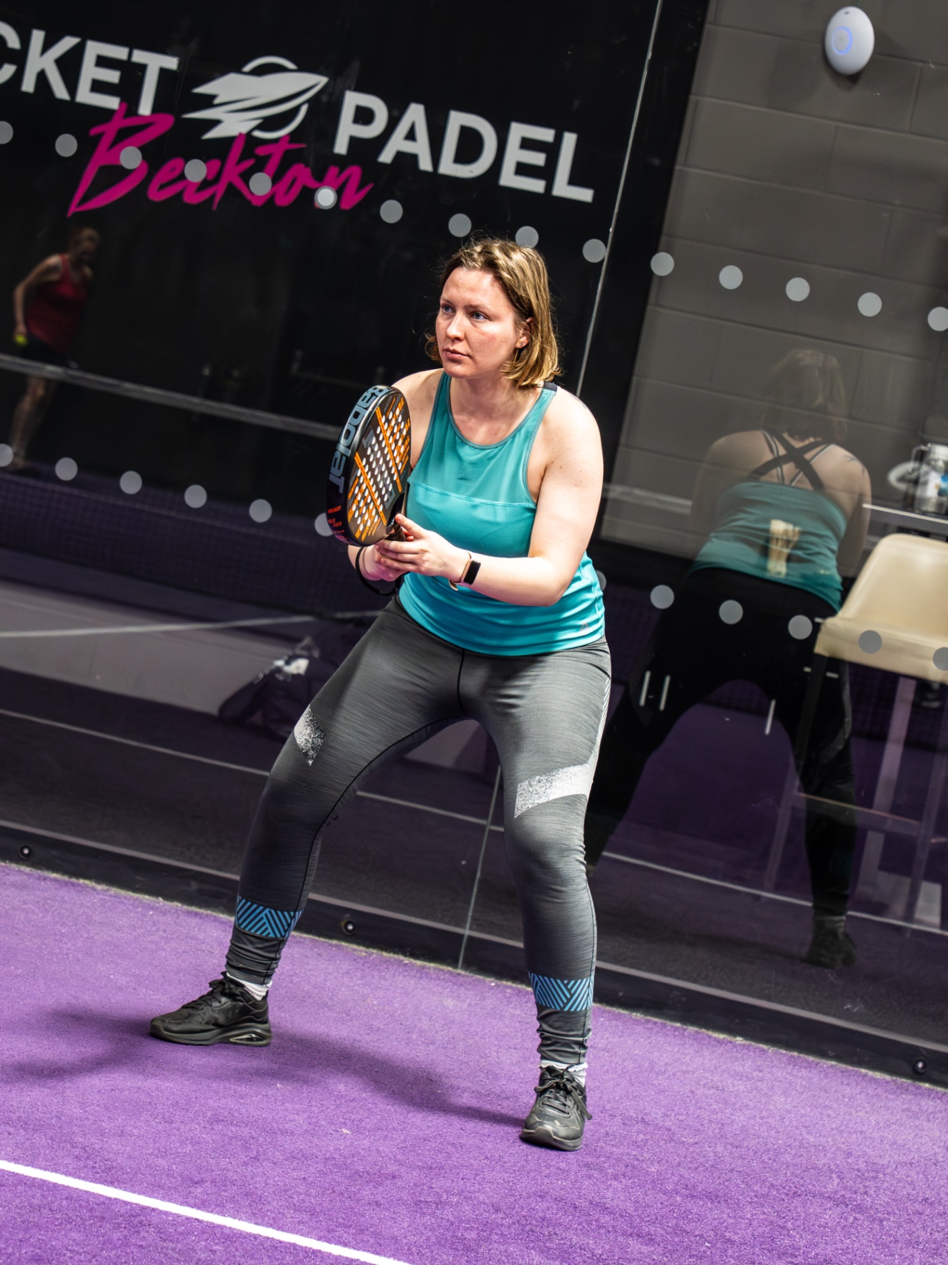 Player in a ready stance waiting to receive serve