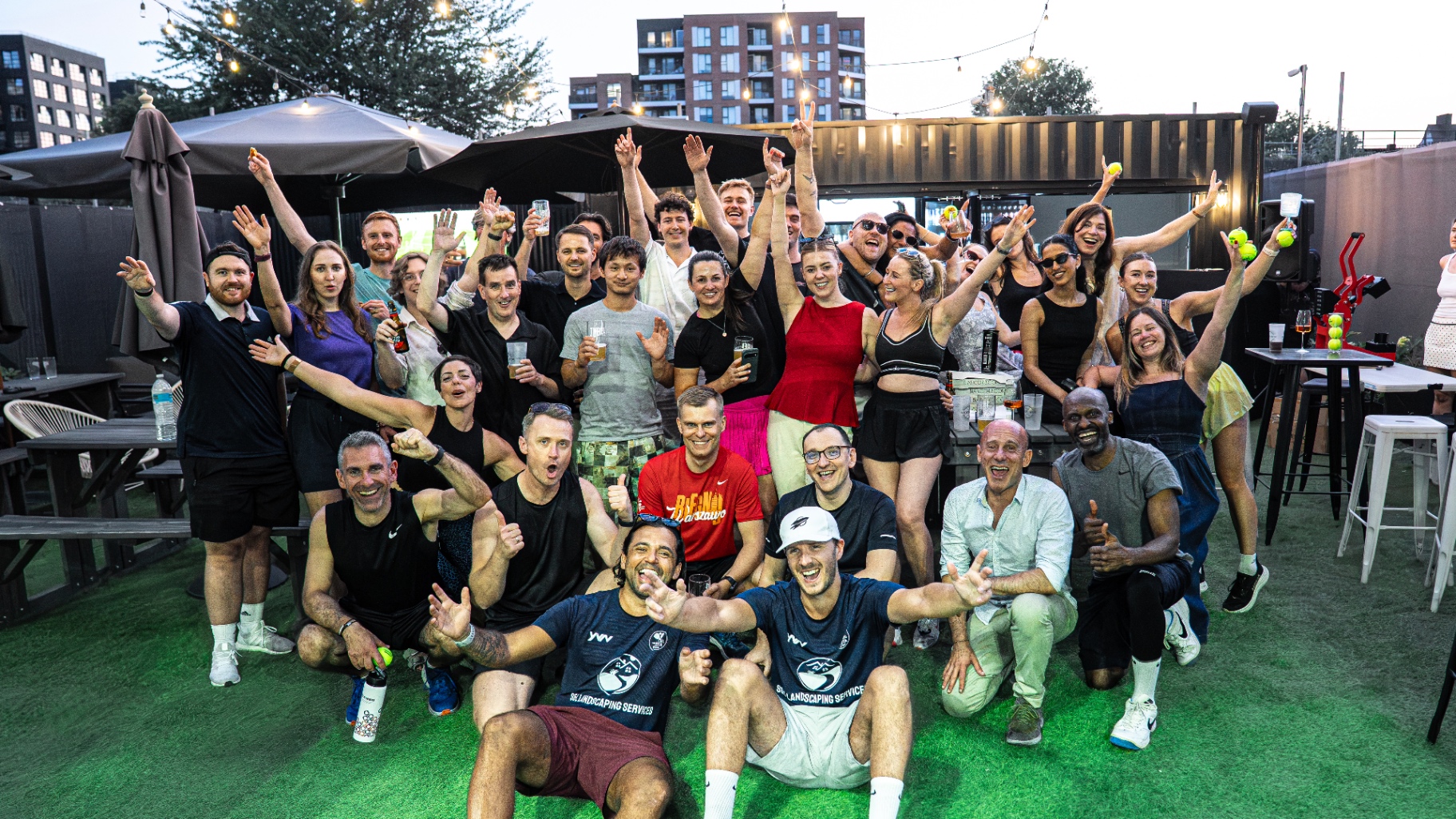 Large group of guests celebrating together at a Padel Fiesta corporate event