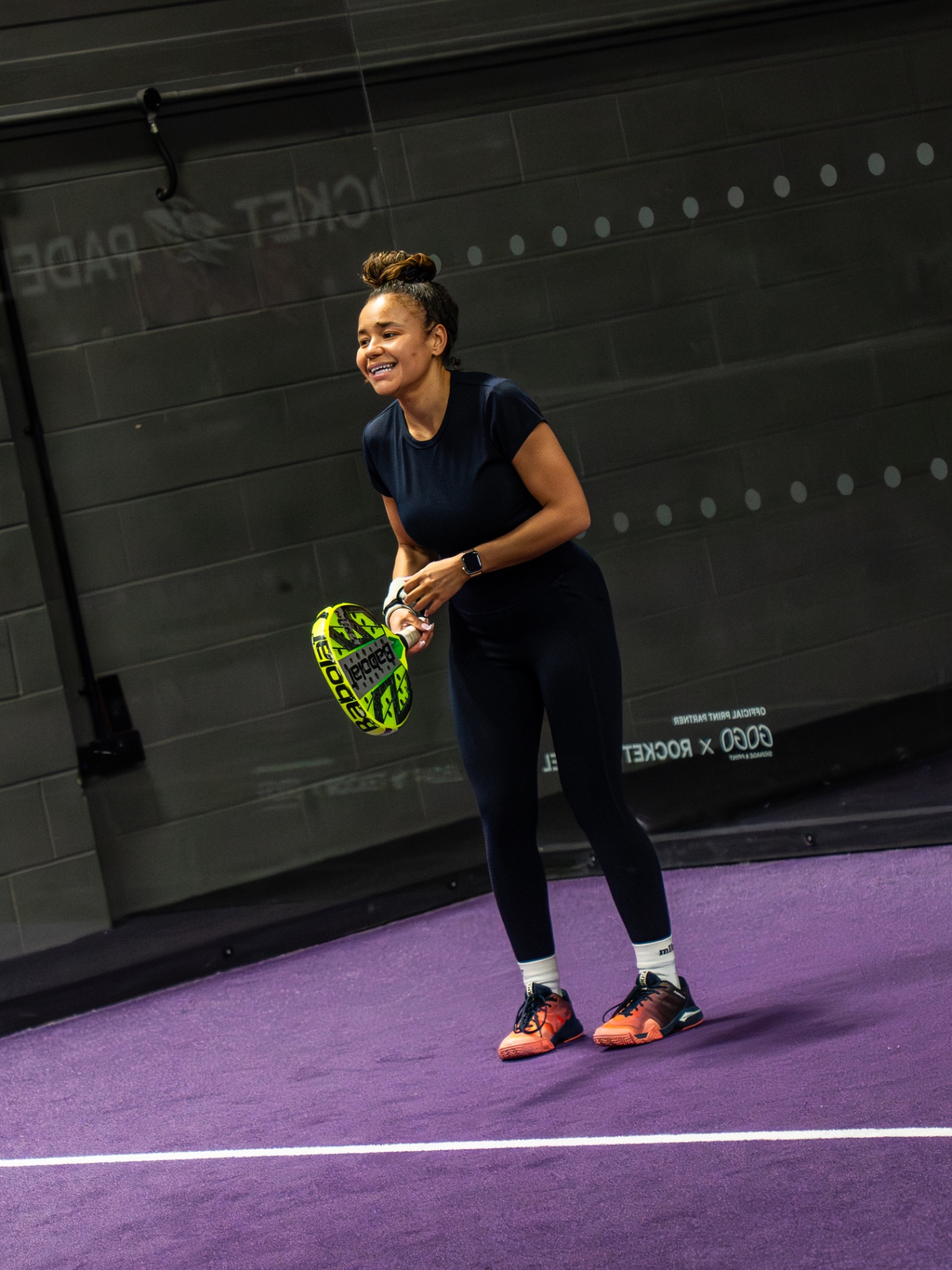 Player laughing while waiting to serve at a Padel Fiesta event